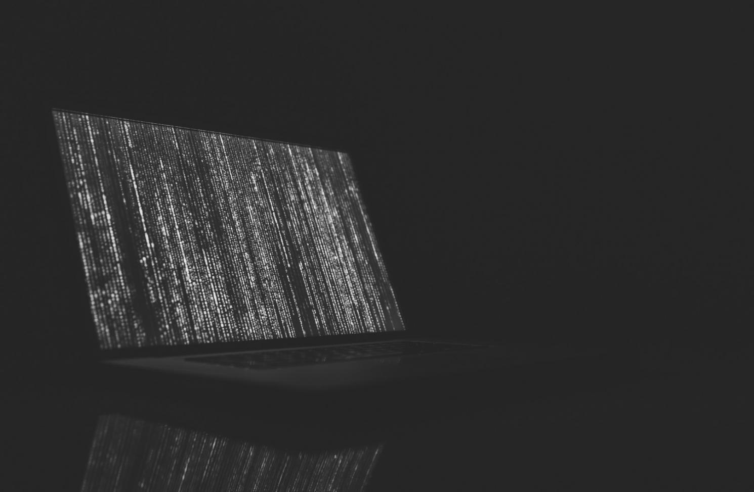 Game development workspace showing multiple monitors with code and performance metrics